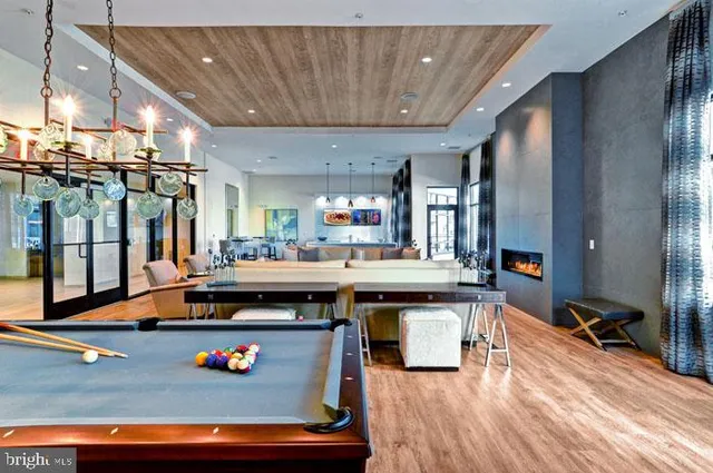 a living room with furniture a air conditioner vent and a large window