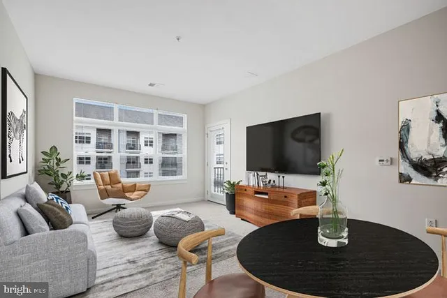 a dining room with furniture and a kitchen view
