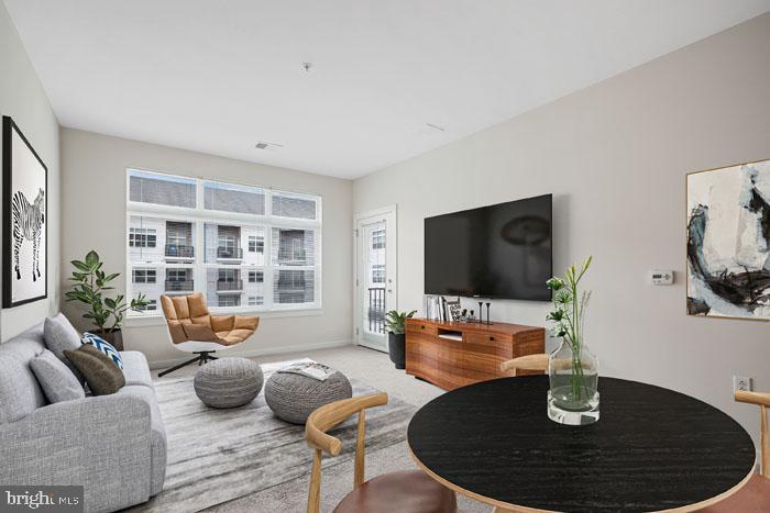 131 Bridge Street, Unit 2B22416 Phoenixville, PA 19460 - Photo 19 of 104 a living room with furniture and a flat screen tv