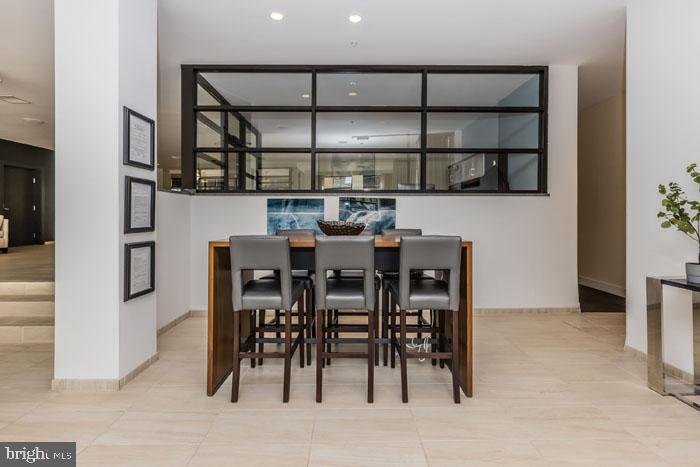 131 Bridge Street, Unit 2B22416 Phoenixville, PA 19460 - Photo 31 of 104 a dining room with furniture and a kitchen view