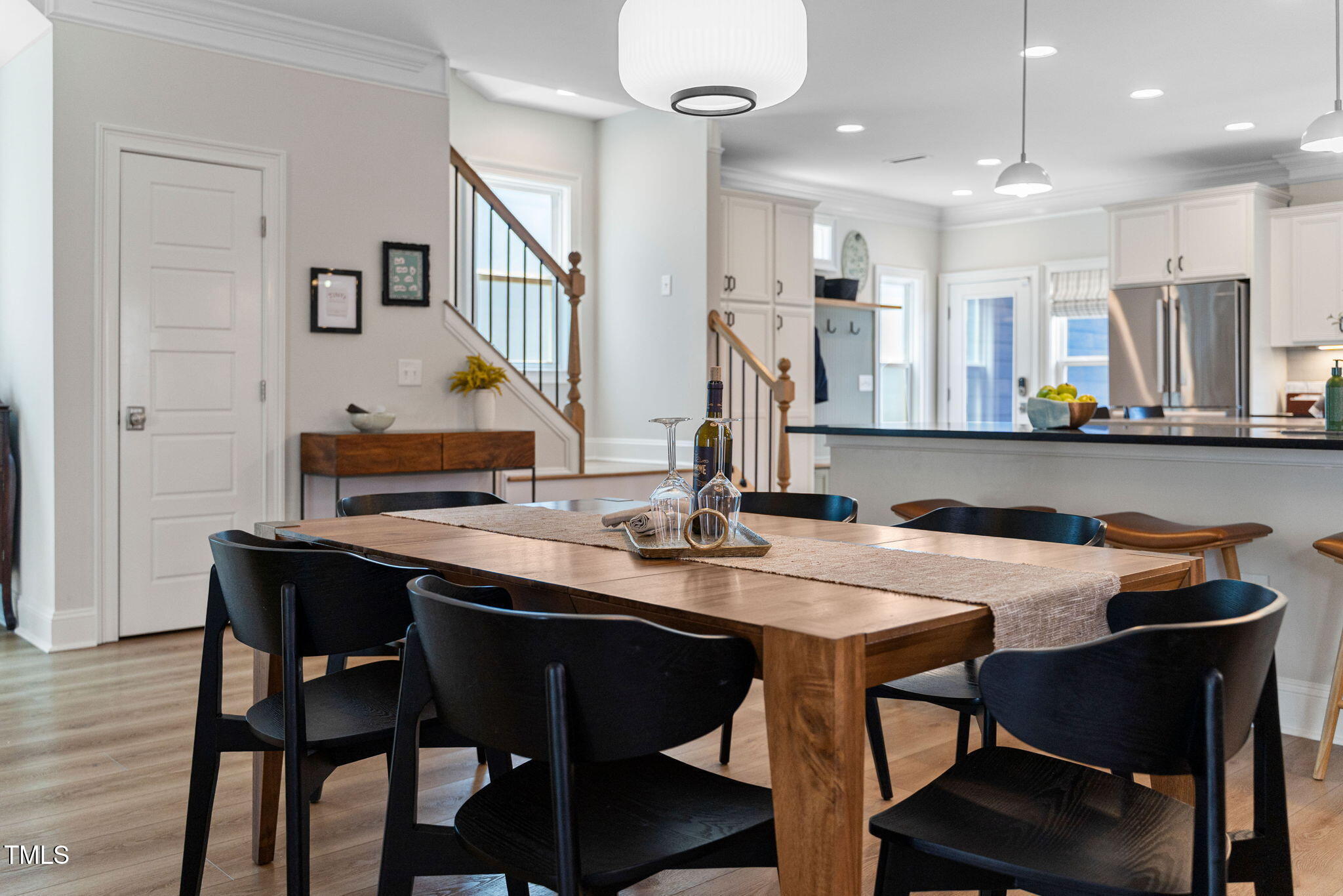 1344 Brown Velvet Lane Apex, NC 27523 - Photo 14 of 63 a room with stainless steel appliances kitchen island granite countertop a table chairs and a refrigerator