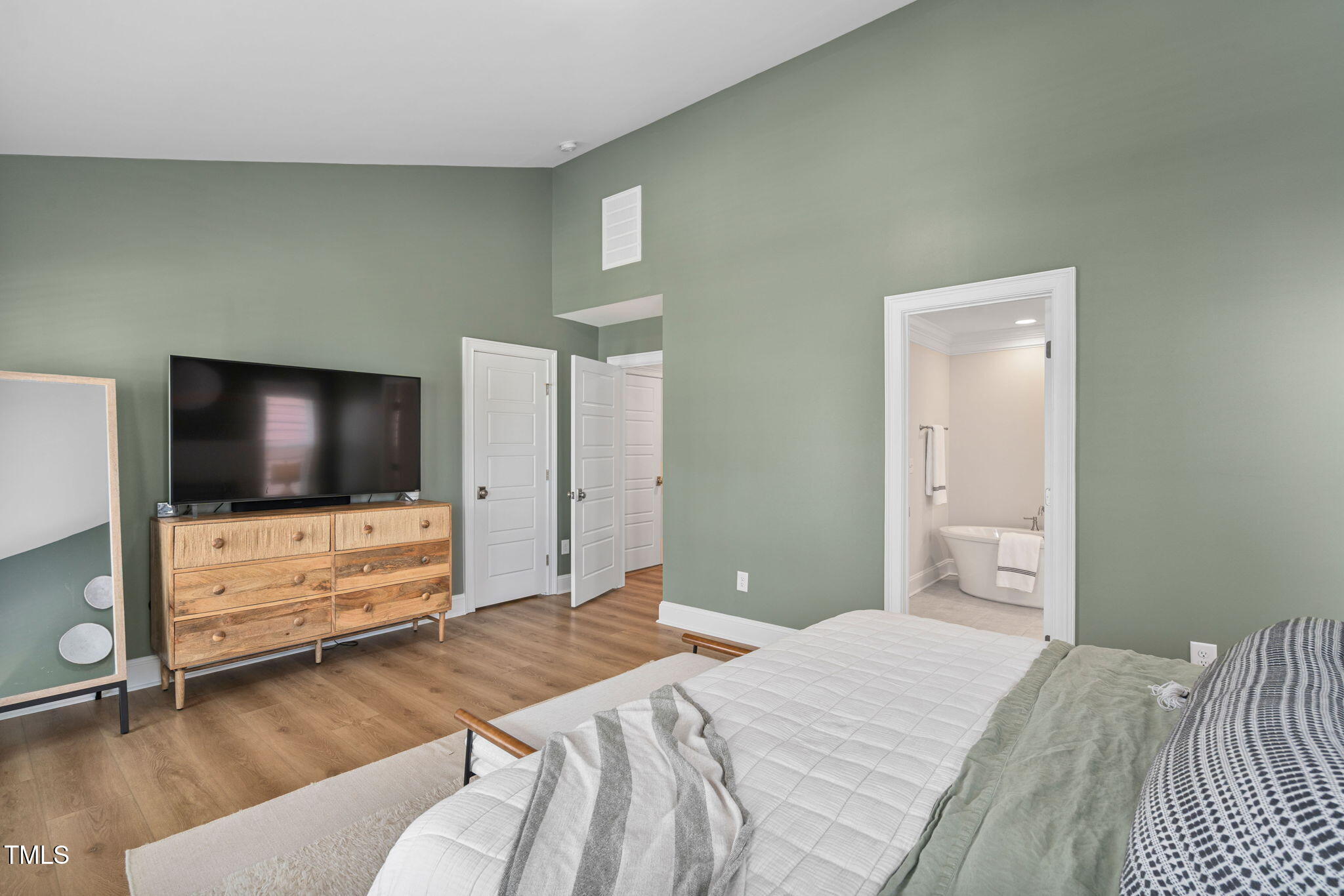 1344 Brown Velvet Lane Apex, NC 27523 - Photo 19 of 63 a bedroom with a bed and a flat screen tv