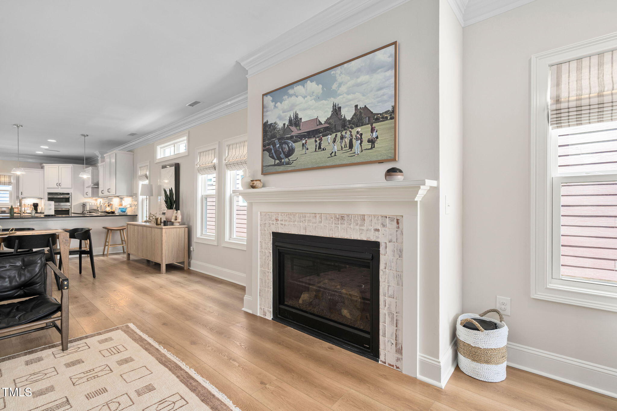 1344 Brown Velvet Lane Apex, NC 27523 - Photo 37 of 63 a living room with stainless steel appliances furniture a fireplace and wooden floor