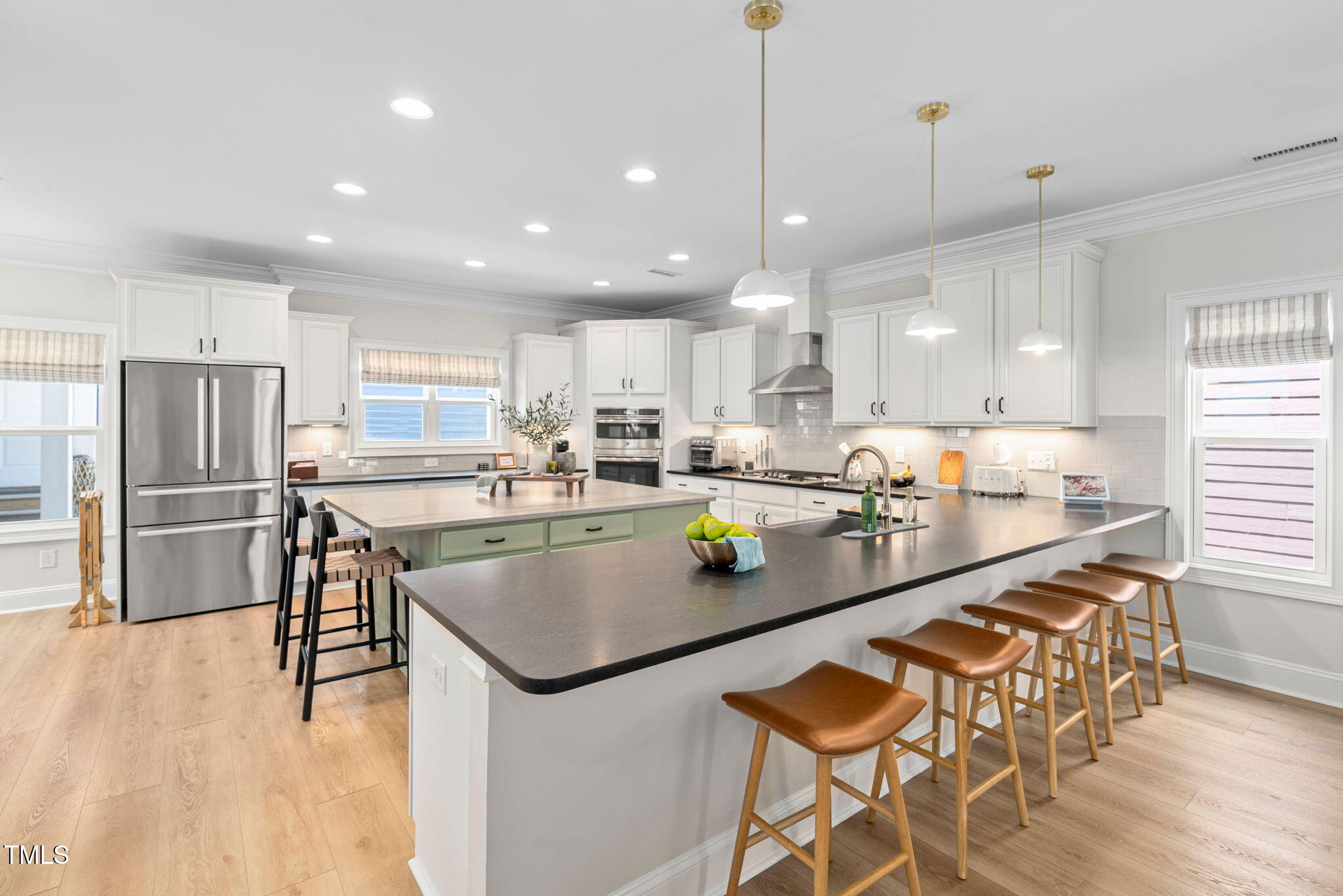 1344 Brown Velvet Lane Apex, NC 27523 - Photo 5 of 63 a kitchen with stainless steel appliances granite countertop a sink a stove a refrigerator and chairs