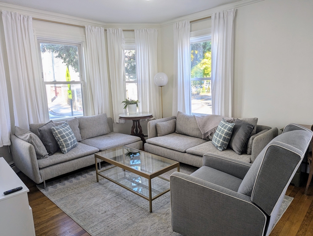 60 Day Street, Unit 1 Boston, MA 02130 - Photo 2 of 10 a living room with furniture and a window