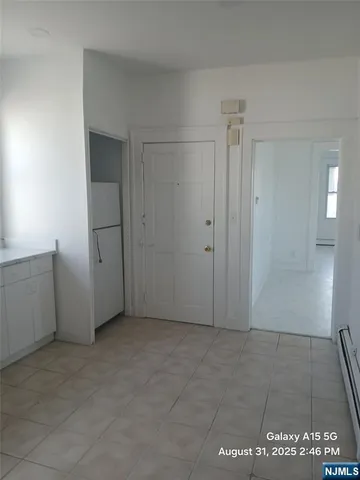 a view of a hallway with wooden floor and furniture