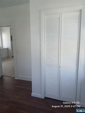 a view of a room with wooden floor