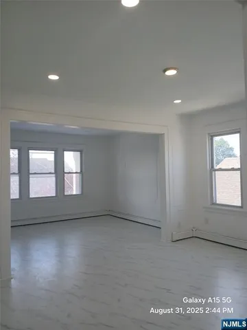 an empty room with a empty space and windows