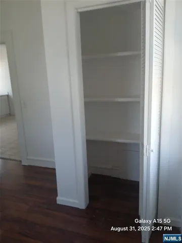 a kitchen with stainless steel appliances granite countertop a sink window and cabinets