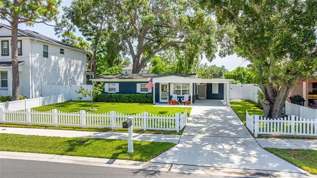 a view of a house with a patio and a yard