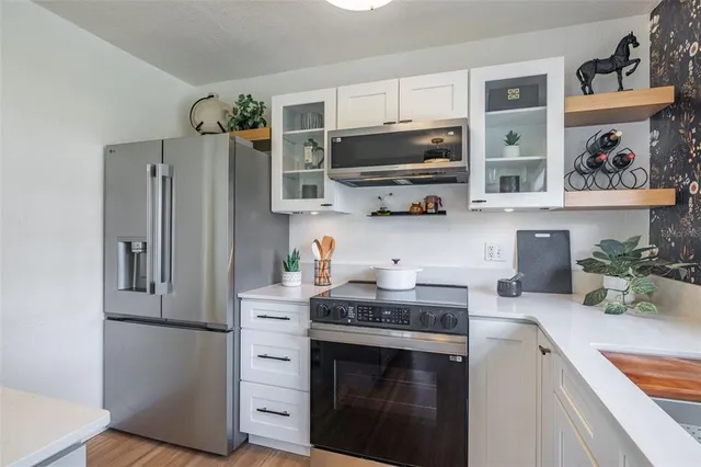 a kitchen with a sink and wooden cabinets