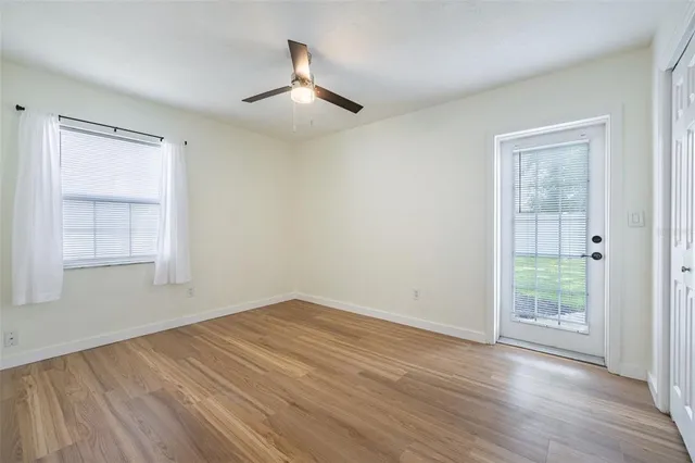 a view of an empty room with wooden floor