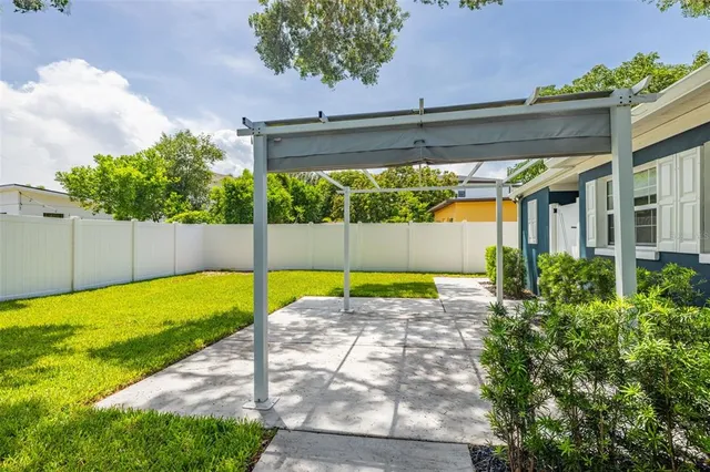 a view of a backyard with a tree