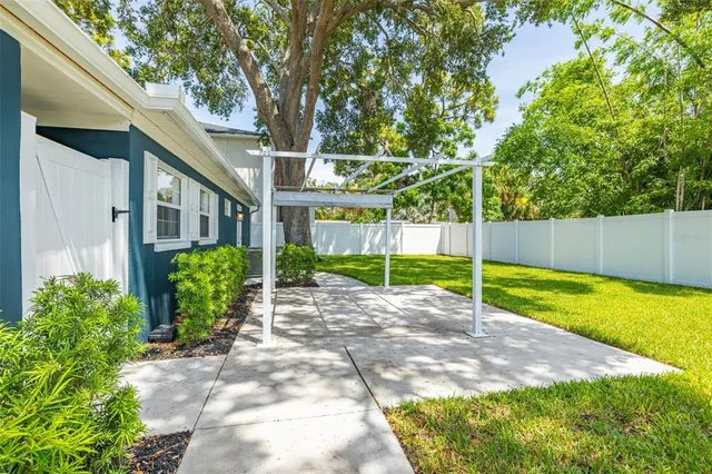 a view of yard with swimming pool and green space