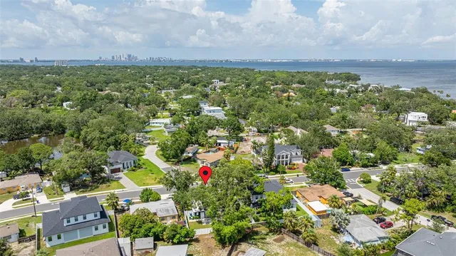 an aerial view of a houses with a yard