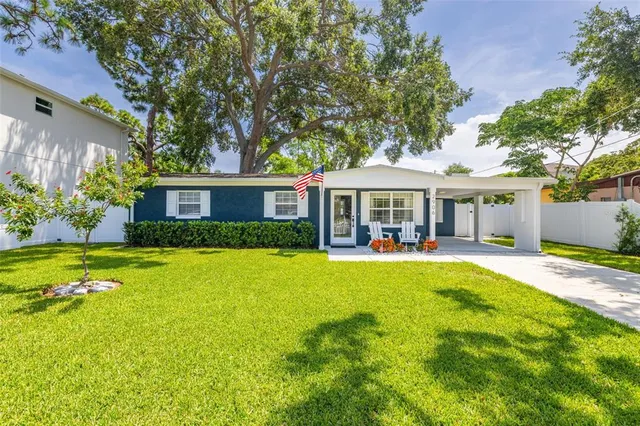 a front view of a house with swimming pool having outdoor seating