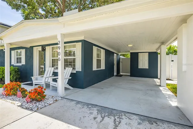 a view of a house with porch and seating space