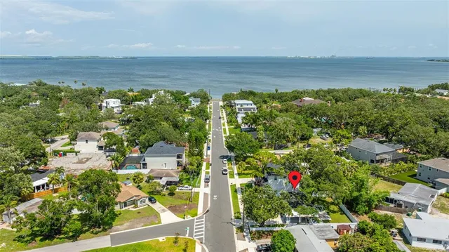 a kitchen with kitchen island granite countertop a sink appliances cabinets and a counter top space