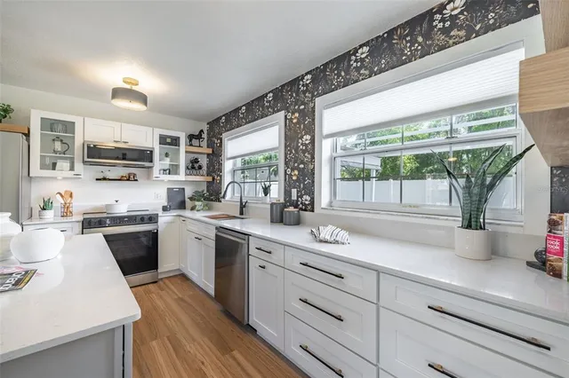 a kitchen with a sink stove and cabinets