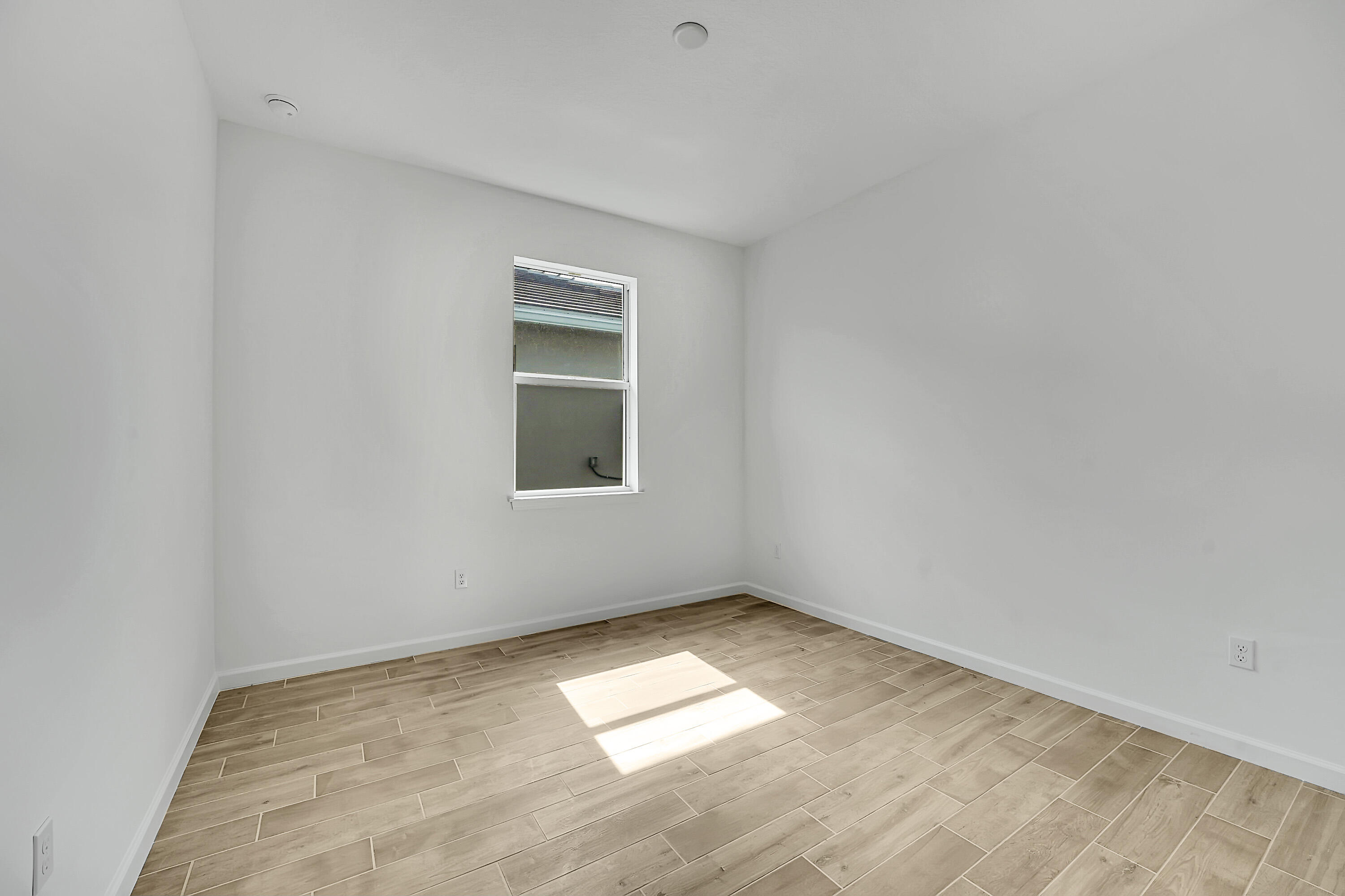 4572 Nautilus Circle Vero Beach, FL 32967 - Photo 14 of 33 a view of empty room with wooden floor and fan