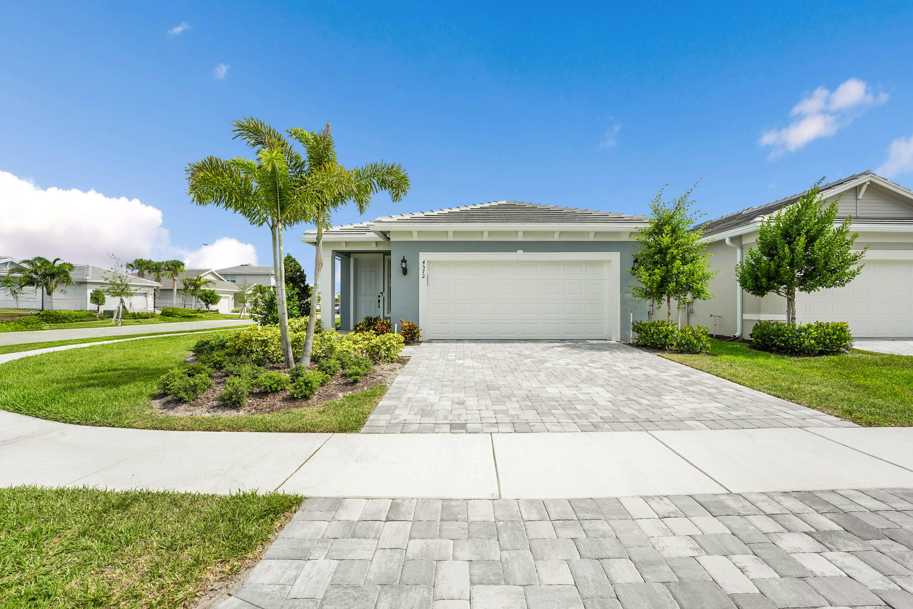 4572 Nautilus Circle Vero Beach, FL 32967 - Photo 23 of 33 a front view of a house with a garden