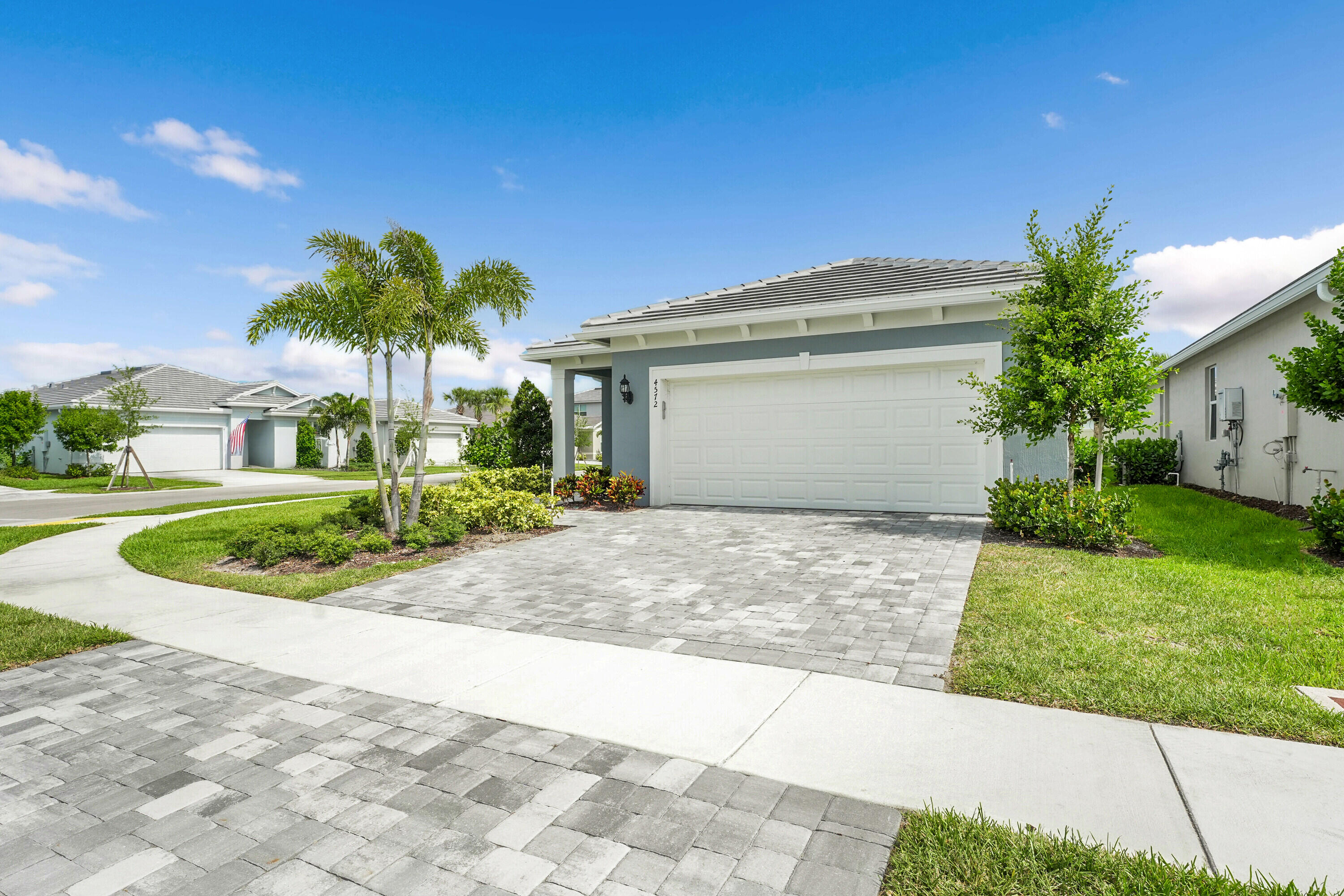 4572 Nautilus Circle Vero Beach, FL 32967 - Photo 25 of 33 a view of a house with a yard and potted plants