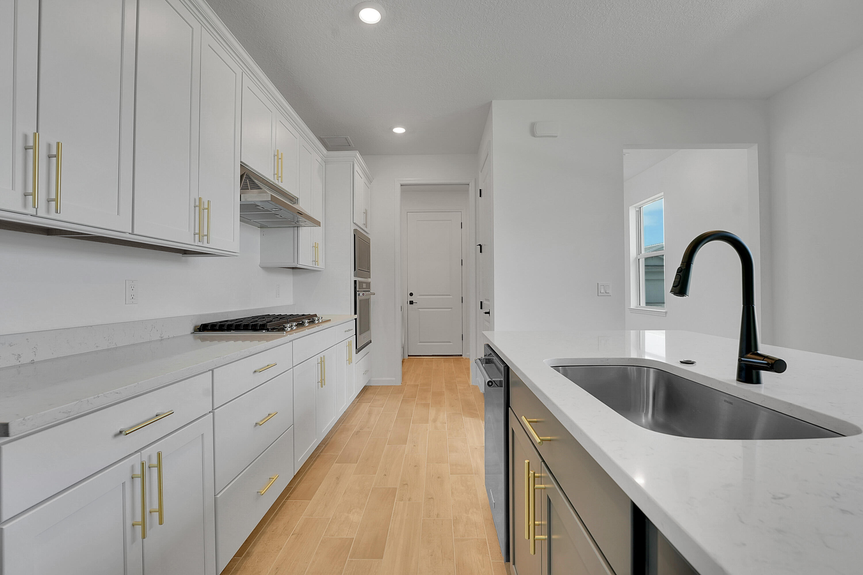 4572 Nautilus Circle Vero Beach, FL 32967 - Photo 5 of 33 a kitchen with granite countertop a sink and white cabinets