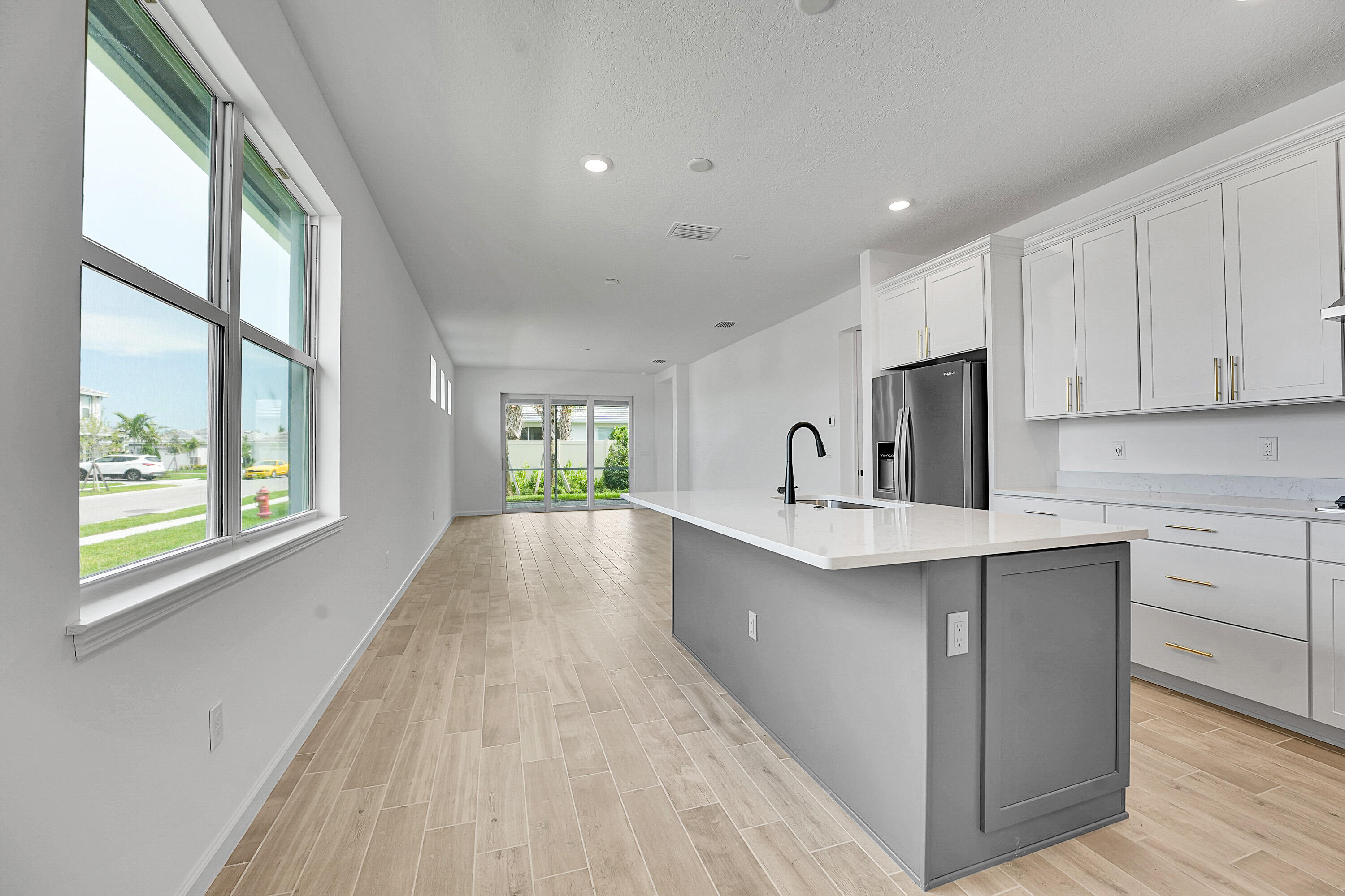 4572 Nautilus Circle Vero Beach, FL 32967 - Photo 7 of 33 a kitchen with a sink a window and cabinets