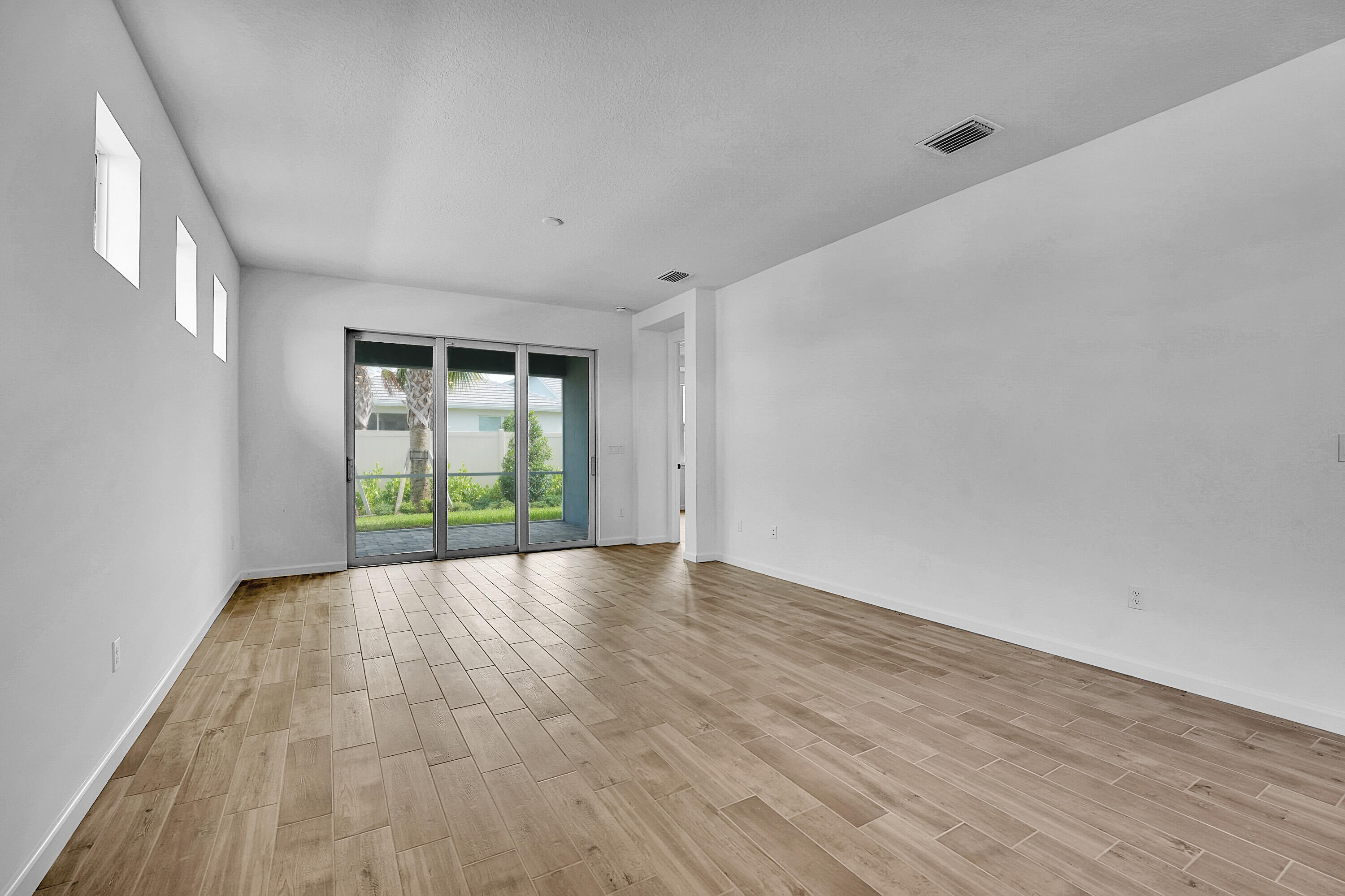 4572 Nautilus Circle Vero Beach, FL 32967 - Photo 8 of 33 a view of an empty room with wooden floor and a window