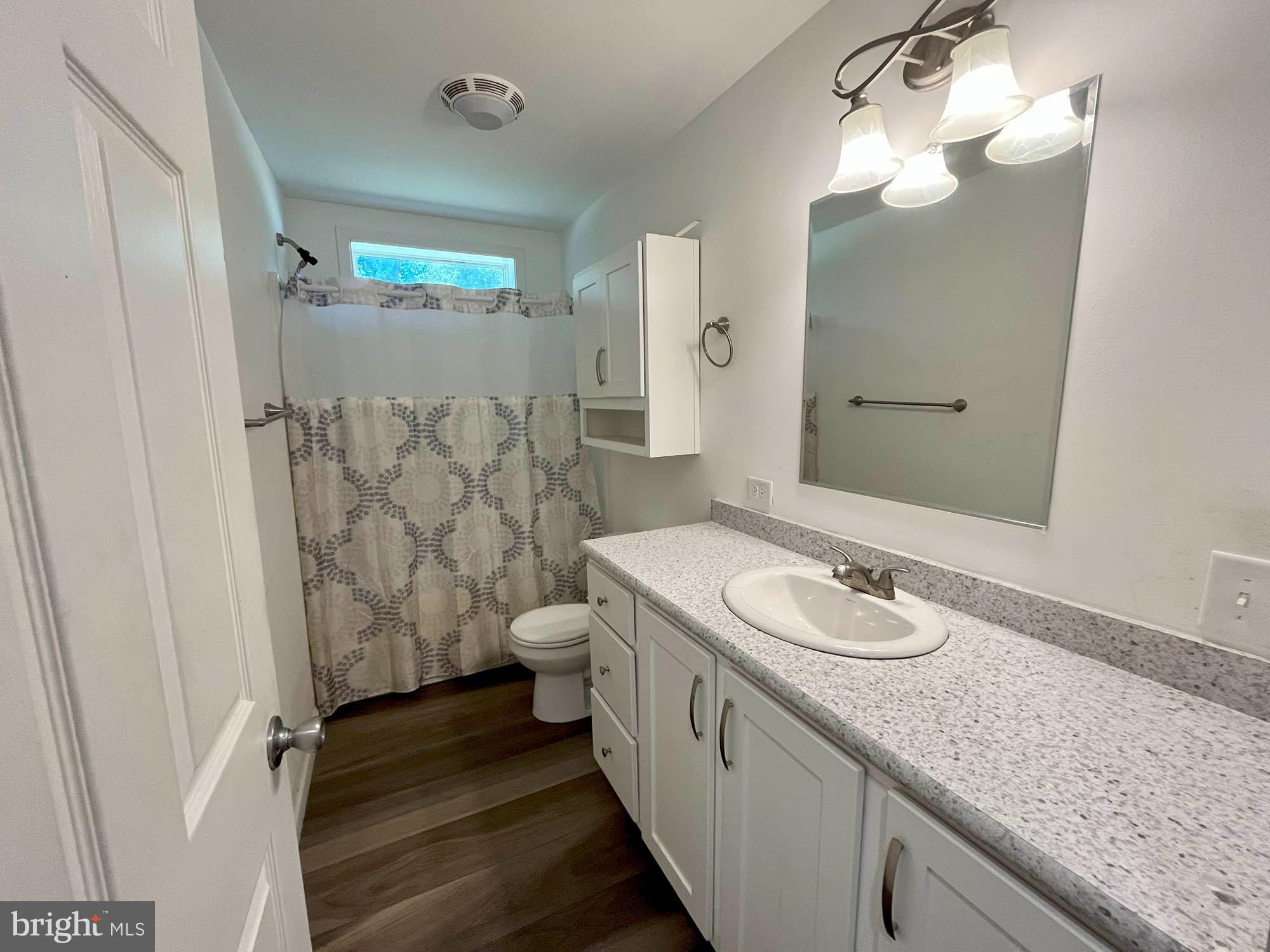 801 Lagrange Road Street, MD 21154 - Photo 15 of 33 a bathroom with a granite countertop sink toilet and shower