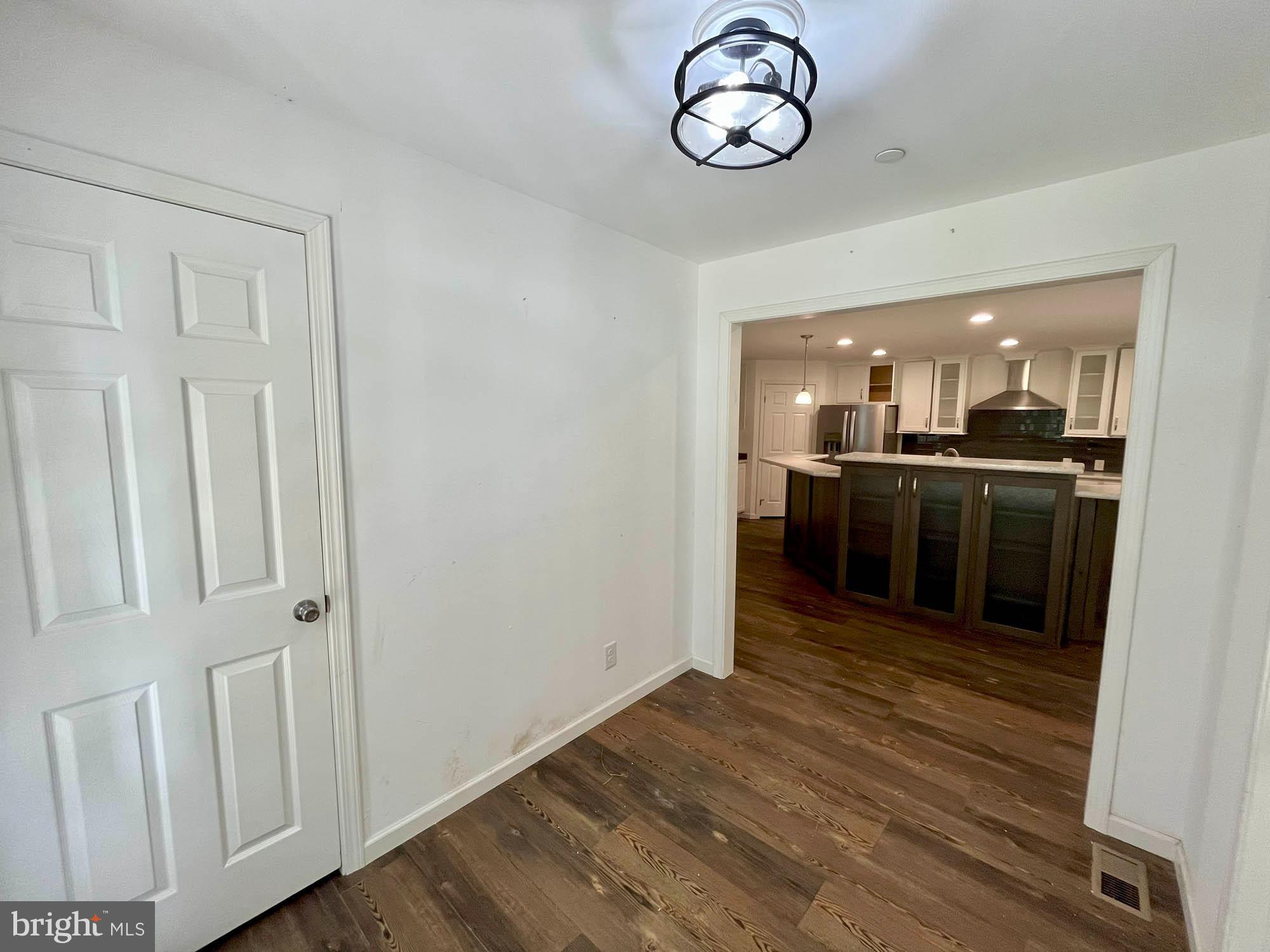 801 Lagrange Road Street, MD 21154 - Photo 4 of 33 an open kitchen with wooden floor and stainless steel appliances