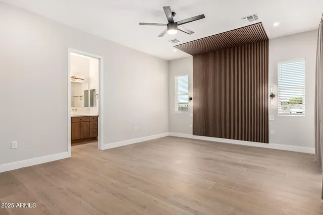 a bathroom with a granite countertop sink toilet and a mirror
