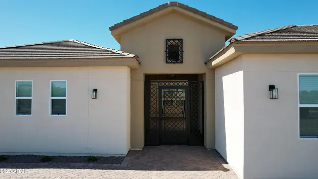 a view of a house with backyard and sitting area