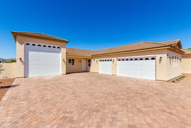 an aerial view of a house with a yard and garage