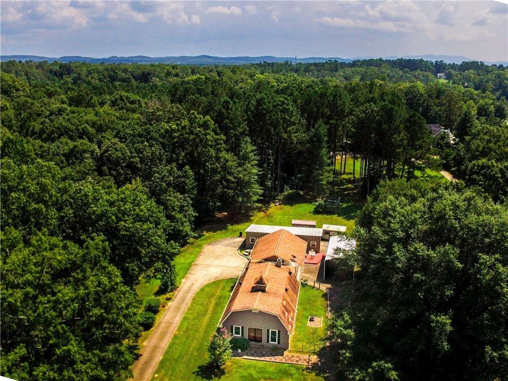 an aerial view of a house with a swimming pool and garden
