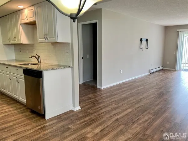 a kitchen with a sink and a stove top oven