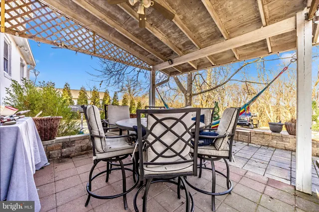 a view of a brick house with a large tree front of the house
