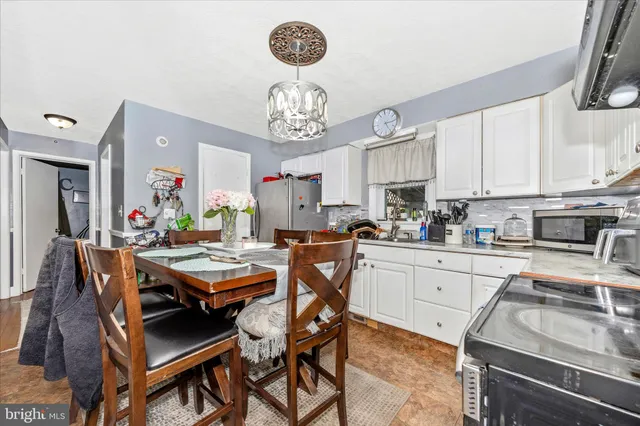 a kitchen with a dining table and chairs