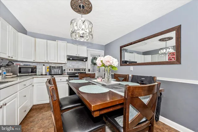 a kitchen with a stove a sink and a microwave