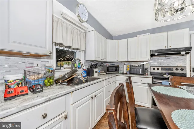 a living room with furniture and a book shelf