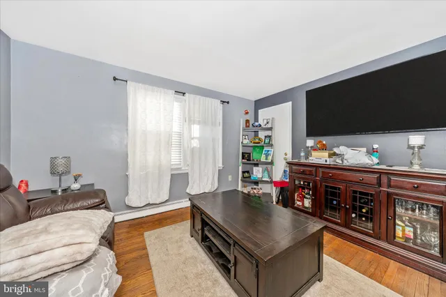 a living room with furniture window and a flat screen tv