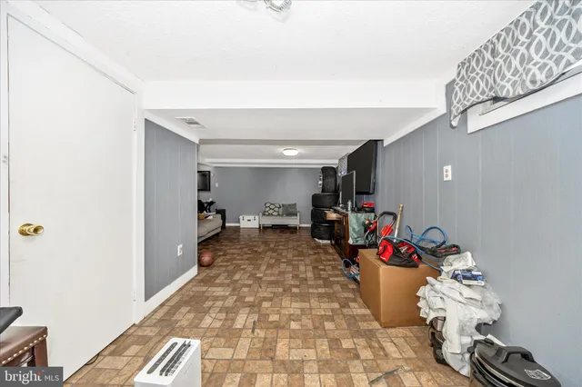 a bedroom with a bed a flat screen tv and dresser