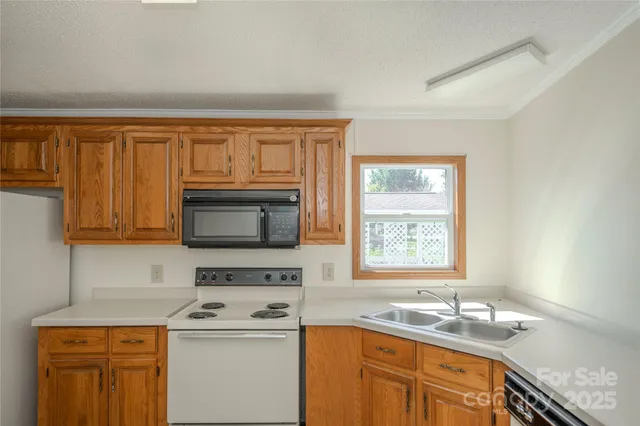 a kitchen with stainless steel appliances granite countertop a sink stove and microwave