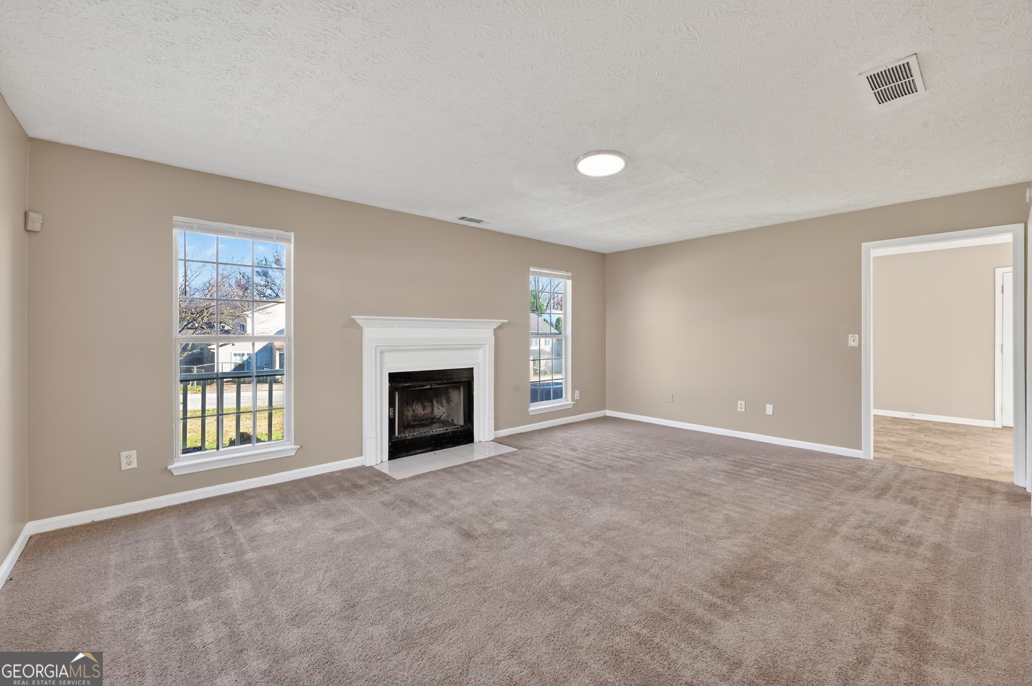 1931 Cornell Way Morrow, GA 30260 - Photo 13 of 33 a view of an empty room with a fireplace and a window