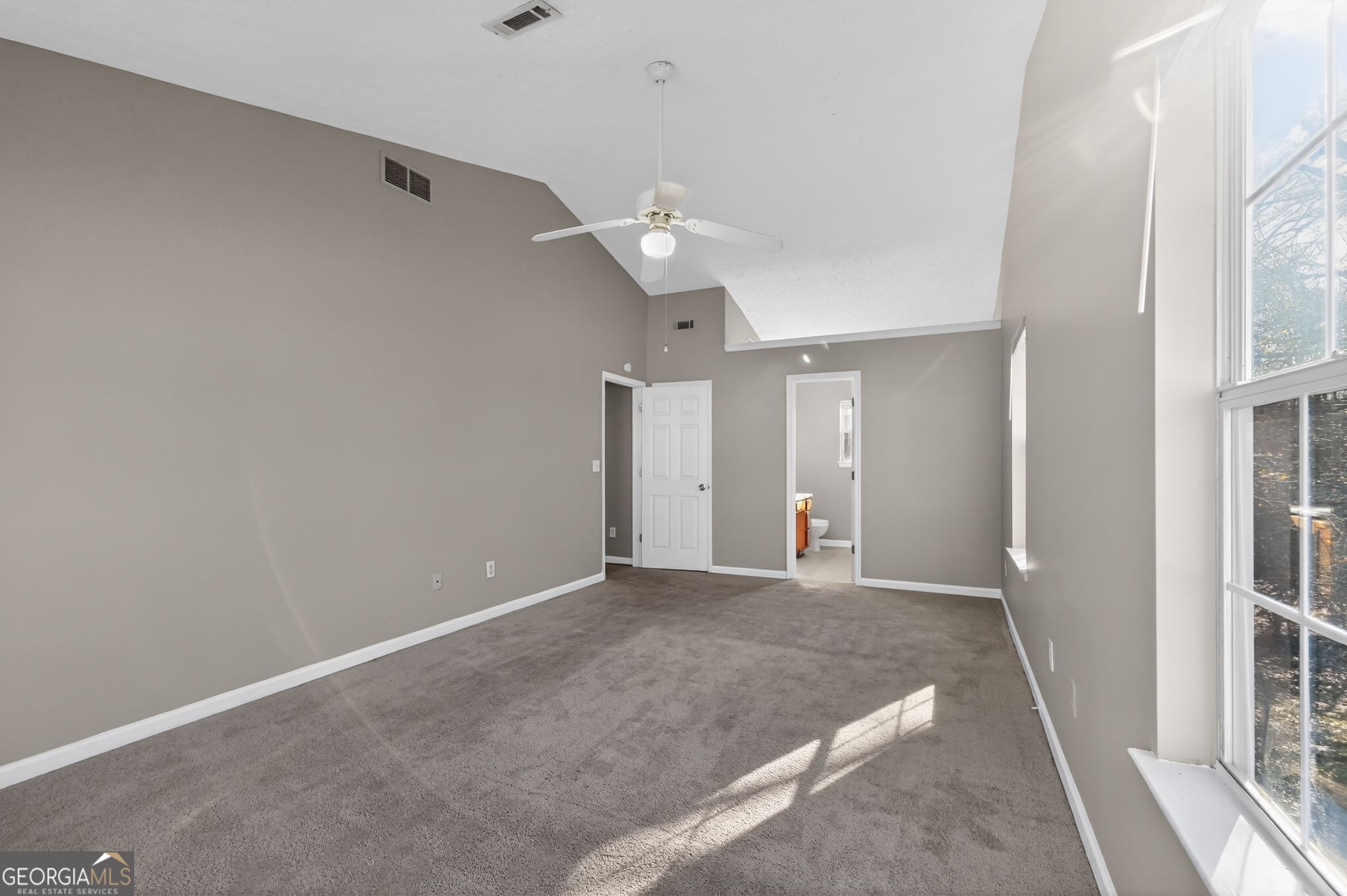 1931 Cornell Way Morrow, GA 30260 - Photo 19 of 33 en empty room with windows and ceiling fan