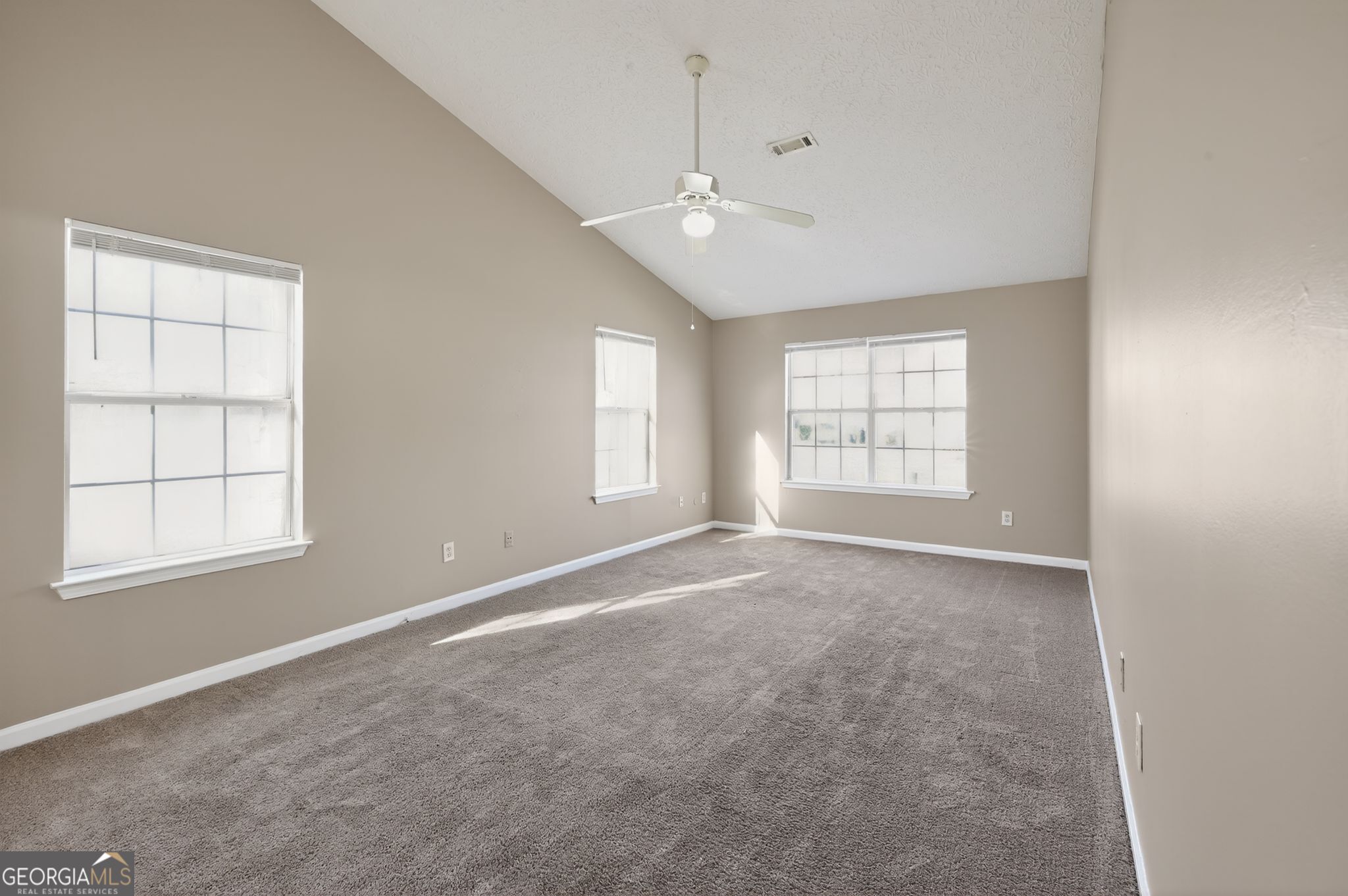 1931 Cornell Way Morrow, GA 30260 - Photo 5 of 33 an empty room with windows and chandelier fan