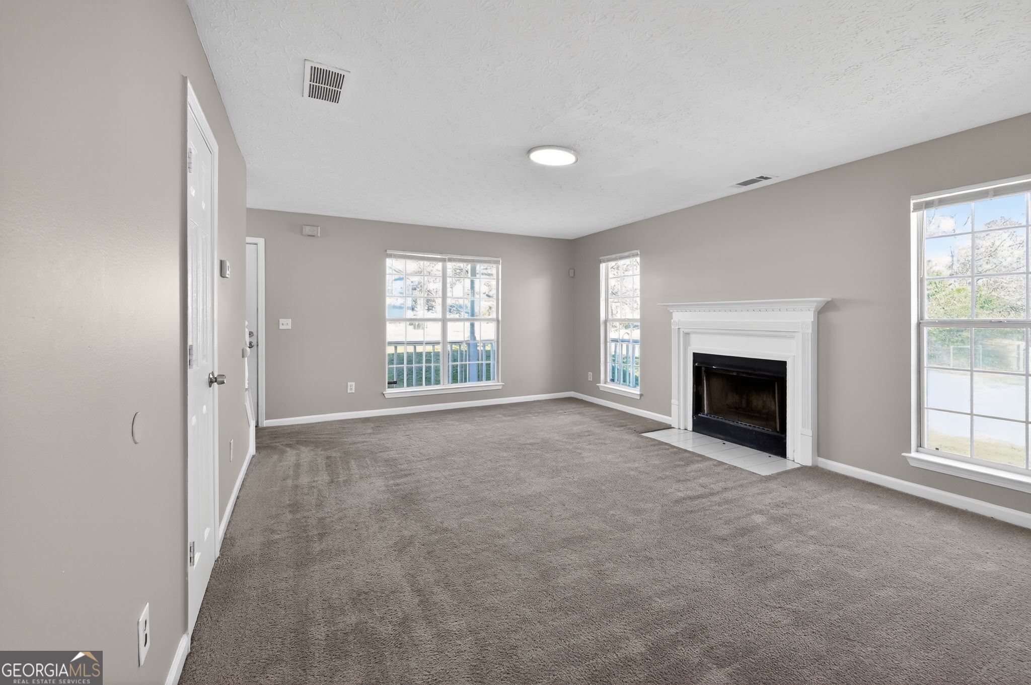 1931 Cornell Way Morrow, GA 30260 - Photo 8 of 33 an empty room with windows and fireplace