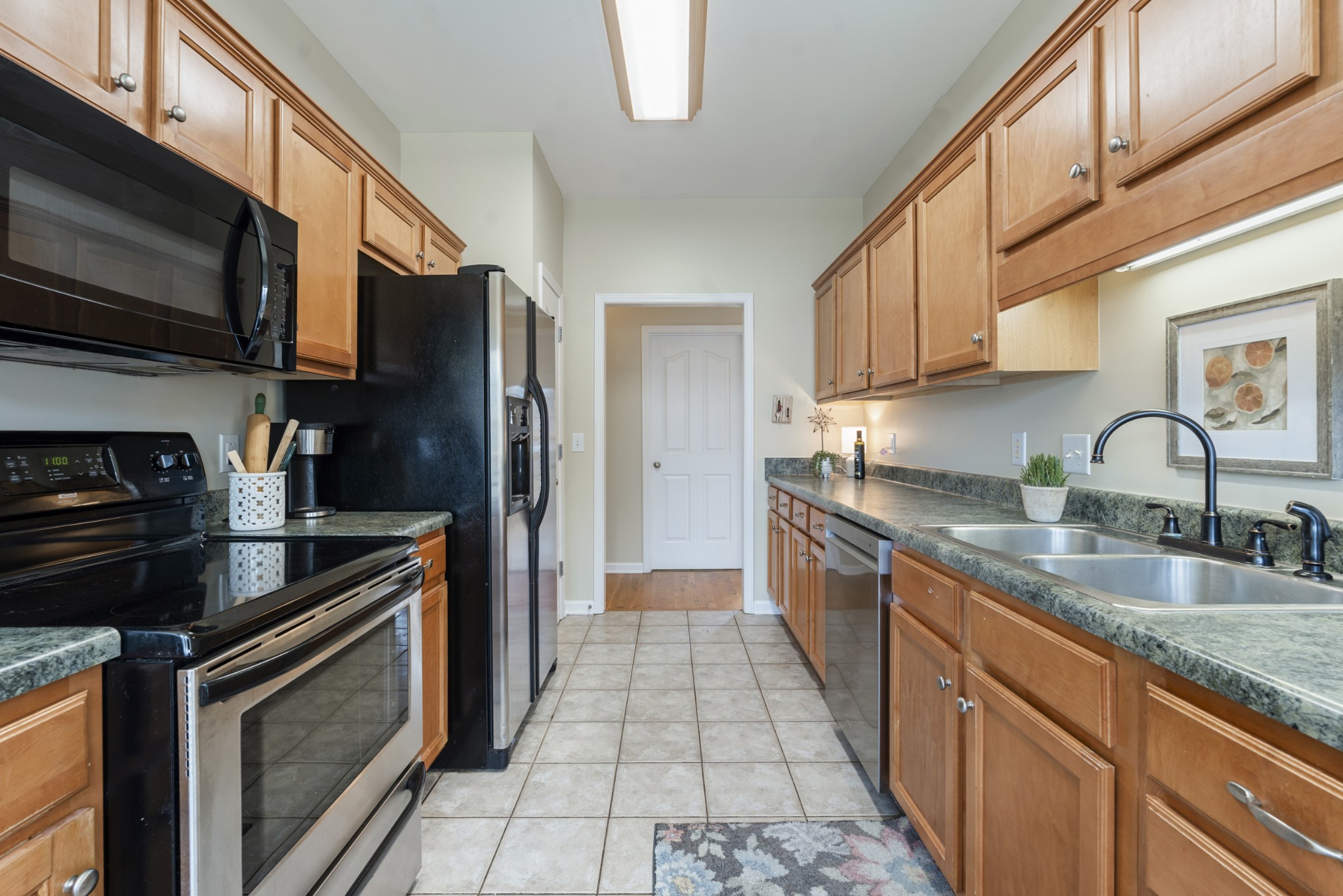 2611 Mission Ridge Drive Murfreesboro, TN 37130 - Photo 12 of 27 a kitchen with stainless steel appliances granite countertop a stove a sink and a microwave