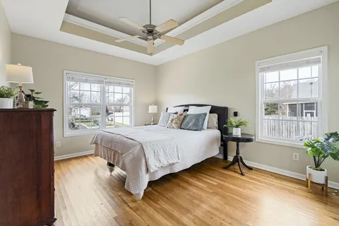 a bedroom with a bed and wooden floor