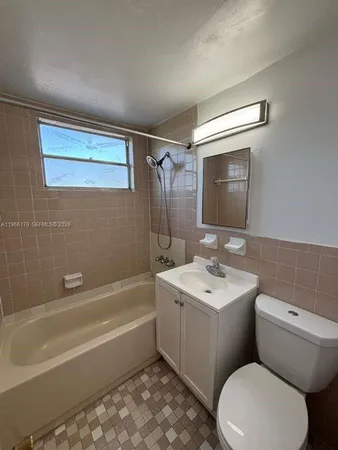 a bathroom with a toilet a sink and bathtub